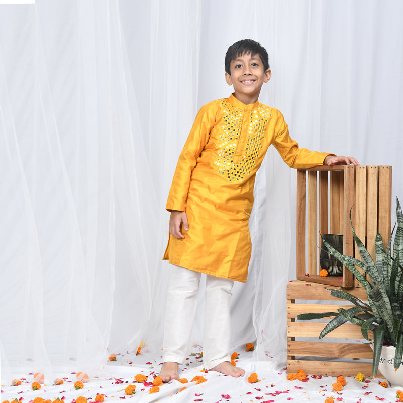 mustard silk kurta with heavy mirrorwork detailing on the neck.