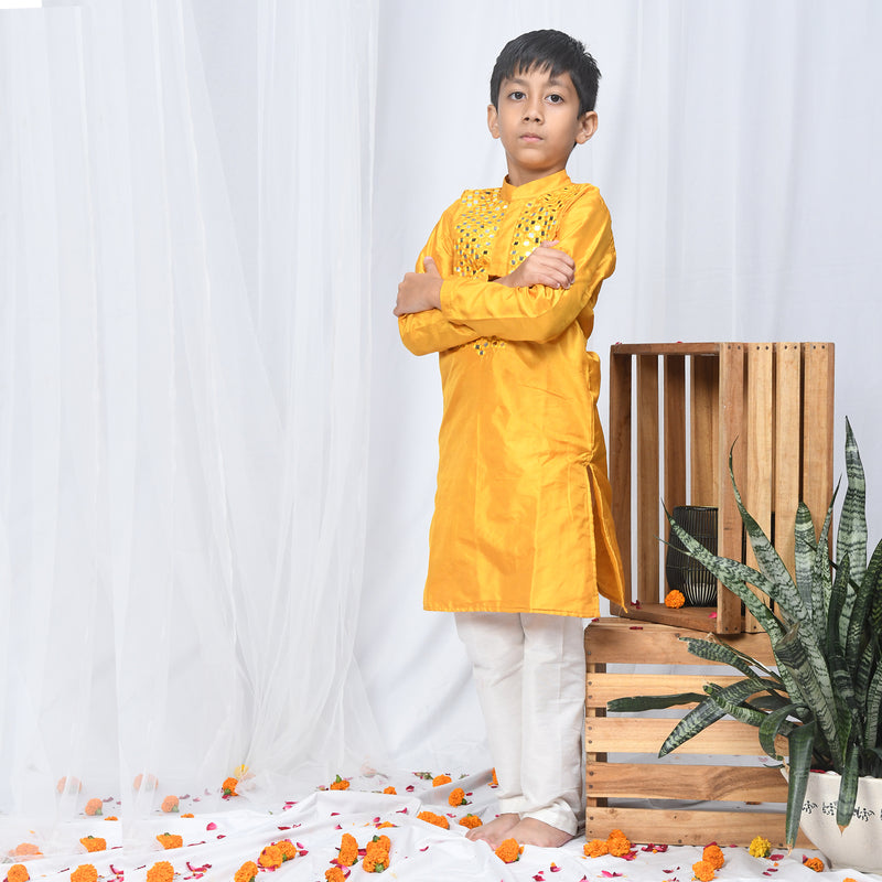 mustard silk kurta with heavy mirrorwork detailing on the neck.