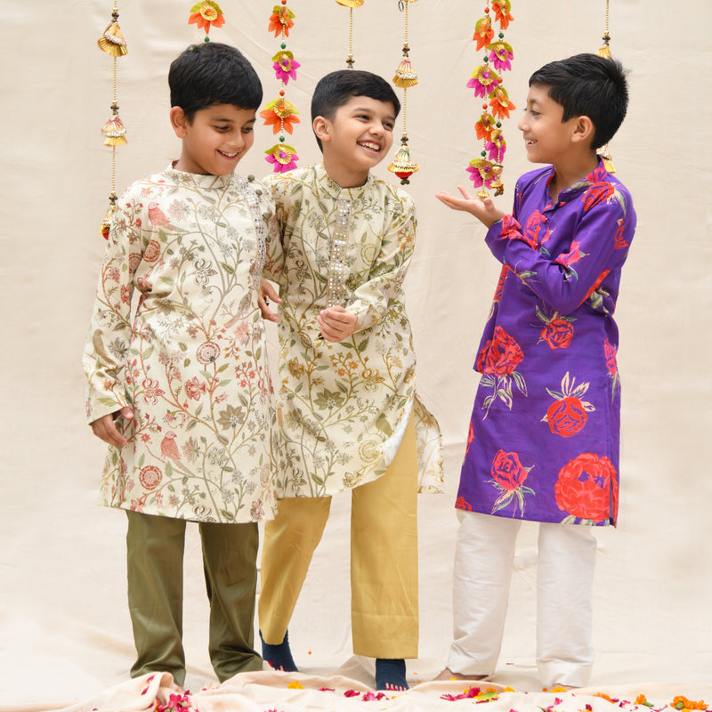 purple kurta with red flowers printed on it with pants